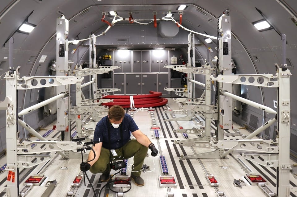 UES Scientist Brett Edwards collecting air velocity measurements in the cargo bay of a KC-46, which is outfitted for aeromedical evacuation